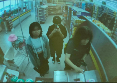 a picture of three friends at a Dollarama, made to look cinematic like an abstract film